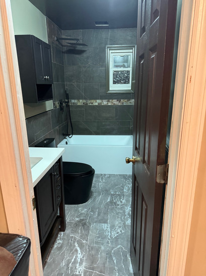 Bathroom remodel in New York City showcasing modern fixtures and sleek design.